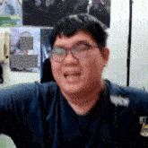 a man wearing glasses and a shirt that says wow is making a funny face