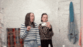 two girls are taking a picture of themselves in the bathroom mirror