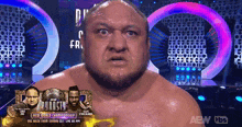 a man with a beard is standing in front of a sign that says aew