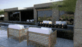 a rendering of a house with chairs and a couch in front of it