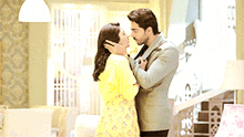 a man and woman kissing in a living room
