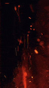 a close up of a fire with sparks flying out of it