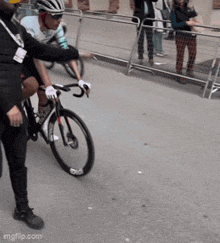 a man wearing a helmet is riding a bike on the street