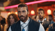 a man with a beard wearing a white shirt and a blue tie