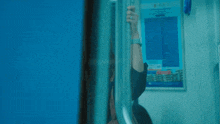 a woman wearing glasses and a watch is holding onto a railing on a train