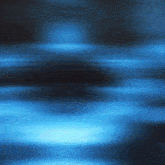 a blurry picture of a dark blue background with a few lights coming out of it