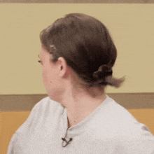 a woman wearing a white shirt with a microphone in her ear