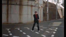 a man in a suit is dancing on a street corner