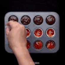 a tray of cupcakes with the word mr.cakes on the bottom right