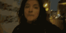 a woman wearing headphones is making a funny face .