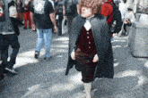 a man in a costume with a cape has a bottle of water in his pocket