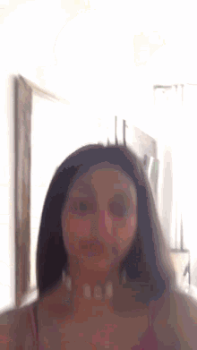 a woman is taking a selfie in front of a mirror .
