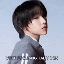 a close up of a person 's face with the words `` vote for jang tae yoon '' written next to it .