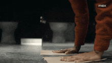 a person 's feet are on a piece of paper with the word max on the bottom left