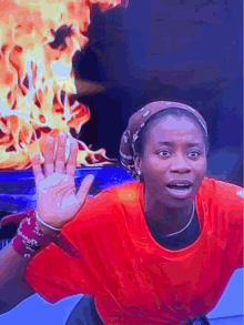 a woman in a red shirt with a bandana that says ' supreme ' on it