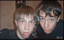 two boys are posing for a picture with the words vidfly ai on the bottom right