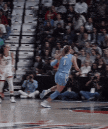 a female basketball player wearing a number 1 jersey