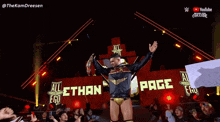 a wrestler is standing in front of a sign that says all ego on it