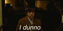 a young man in a brown coat is saying i dunno
