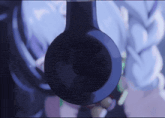 a close up of a pair of headphones with a person in the background