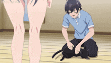 a man is petting a cat while a woman stands behind him