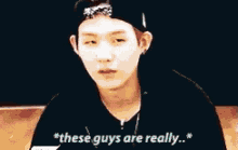a group of young men are giving each other high fives while one of them says `` these guys are really '' .