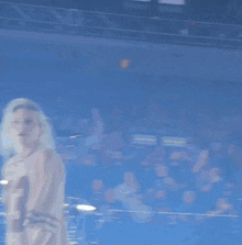 a woman wearing a shirt with the number 93 on it is dancing