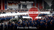a large group of people are gathered in front of a sign that says vom rhein from the rhine