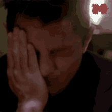 a man covering his face with his hands and a red sticker that says ncf