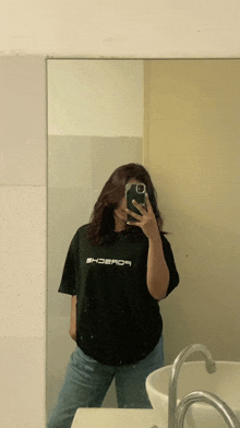 a woman is taking a picture of herself in a mirror