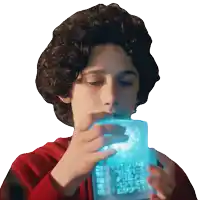a young boy in a red hoodie is drinking from a blue cube that says ' peace ' on it