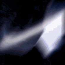 a dark background with a purple arrow pointing to the right