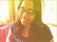 a woman wearing glasses and a shirt that says ' hand ' on it