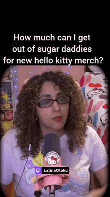 a woman wearing glasses and a hello kitty shirt is talking into a microphone