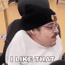a man in a wheelchair wearing a beanie and glasses is saying i like that