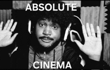a black and white photo of a man with headphones and the words absolute cinema