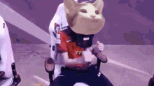 a person is sitting in a chair with a cat 's head on their head .