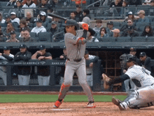 a baseball game is being played in front of a bank of america fence