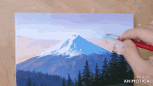 a person is painting a mountain with the words made in animotica below