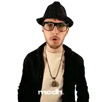 a man wearing glasses and a hat has the word mcdh on the bottom right