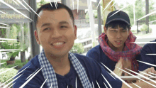 a man wearing a blue shirt and a scarf is smiling and clapping