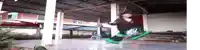 a person is jumping in the air with a green ribbon around their waist .