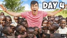 a man in a pink shirt is surrounded by a group of children and the time reads 9:55