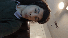 a man wearing headphones looks at the camera in a living room