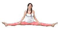 a woman in a white tank top and pink pants does a split