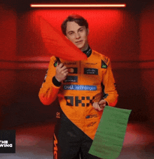a man wearing an orange shirt with dell technologies written on it