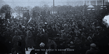a black and white photo of a crowd with the words " and the battle is going again " on the bottom