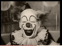 a clown is smiling with his eyes closed
