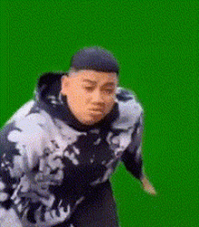 a man is standing in front of a green screen .