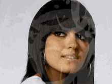 a close up of a woman 's face with a reflection of a person 's face behind her .